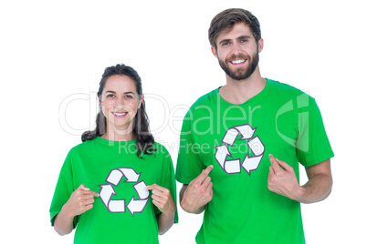 Friends wearing recycling tshirts pointing themselves