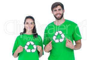 Friends wearing recycling tshirts pointing themselves