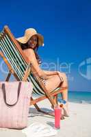Pretty brunette looking at camera on deck chair