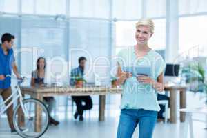 Pretty businesswoman holding a tablet in the office