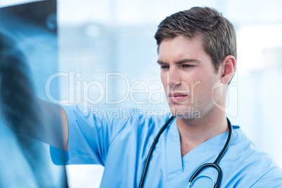 Concentrated doctor analyzing xray