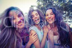 Happy friends covered in powder paint