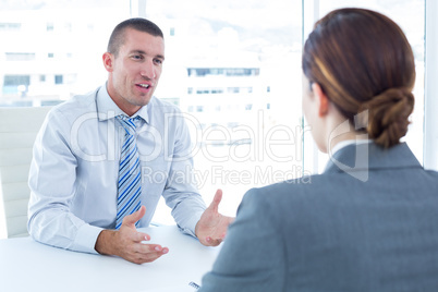 Businessman conducting an interview with businesswoman