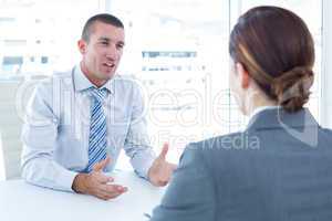 Businessman conducting an interview with businesswoman