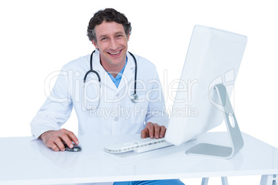 Smiling doctor working on his laptop