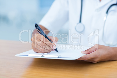Doctor holding clipboard with file Doctor holding clipboard with file