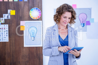 Creative businesswoman using tablet computer