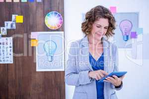 Creative businesswoman using tablet computer