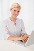 Portrait smiling blonde woman using laptop