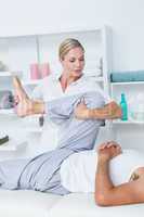 Physiotherapist doing leg massage to her patient