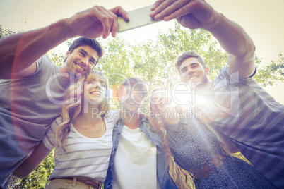 Happy friends in the park taking selfie