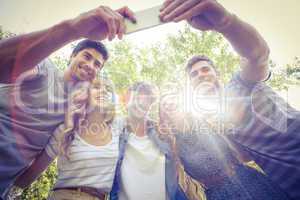 Happy friends in the park taking selfie