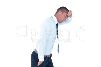 Worried businessman leaning on wall