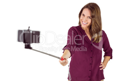 Pretty woman using a selfie stick