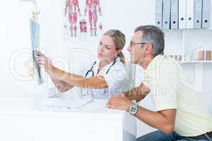 Doctor showing X rays to her patient