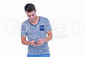 Handsome hipster texting on smartphone