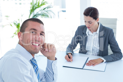 Businesswoman conducting an interview with businessman