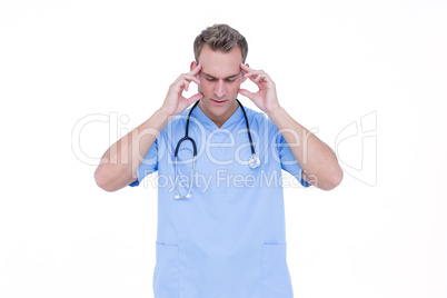 Worried young nurse in blue tunic