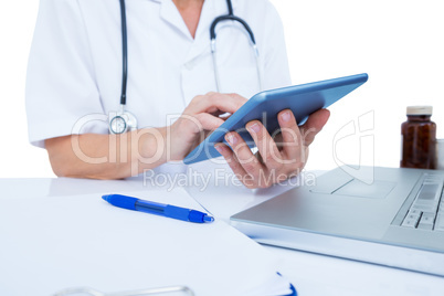 Doctor using a tablet in the office Doctor using a tablet in the office