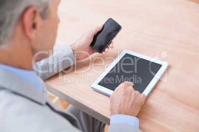Businessman holding tablet and smartphone