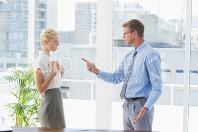 Businessman giving out to his colleague