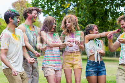 Happy friends throwing powder paint