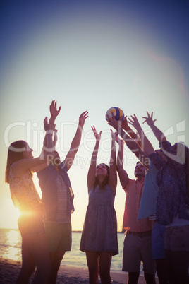 Group of friends playing volleyball