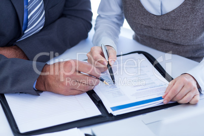 Business people checking file