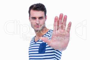 Handsome hipster showing stop sign with hand