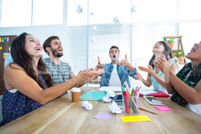 Creative business people throwing paper in the air