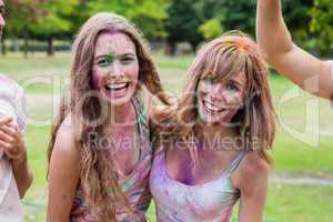 Happy friends covered in powder paint