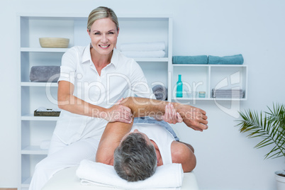 Doctor examining her patient arm