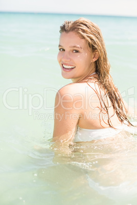 Happy pretty blonde bathing into the sea