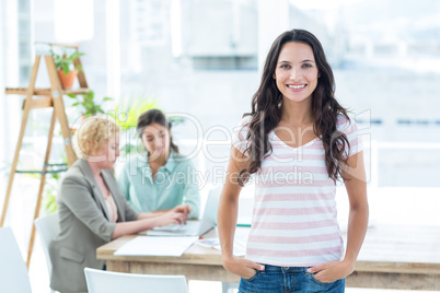 Smiling businesswoman with colleagues