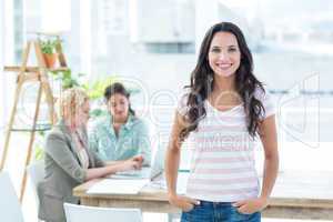 Smiling businesswoman with colleagues