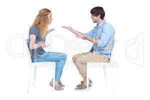 Sitting couple having an argument
