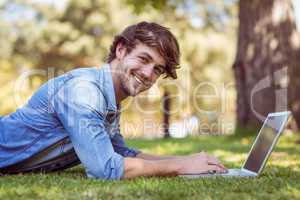 handsome hipster using laptop in park