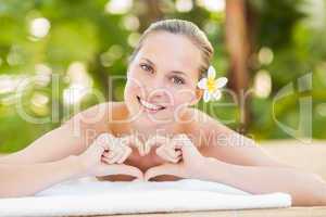 Peaceful blonde lying on towel looking at camera