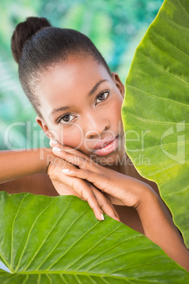 Pretty woman looking through leaves