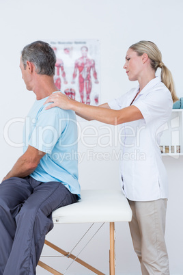 Doctor examining her patient neck