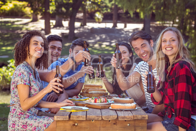 Happy friends in the park having lunch