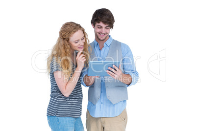 Happy couple holding tablet computer