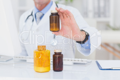 Doctor showing medicine to camera