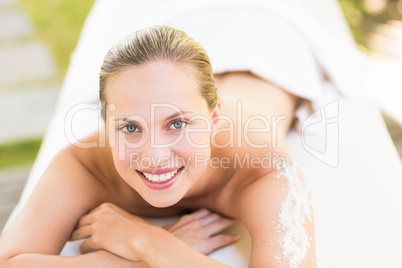 Close up portrait of a beautiful young woman on massage table