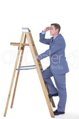 Composite image of businessman standing on ladder looking