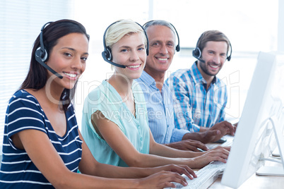 Casual call centre workers looking at the camera
