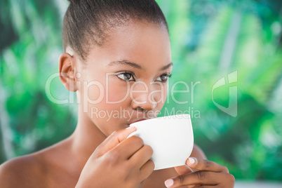 Close up of a beautiful young woman drinking coffee