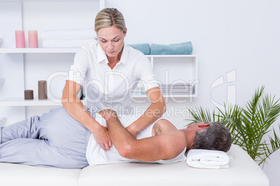 Physiotherapist doing shoulder massage to her patient