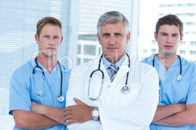 Team of doctors standing arms crossed