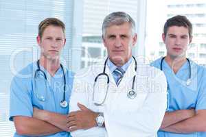 Team of doctors standing arms crossed